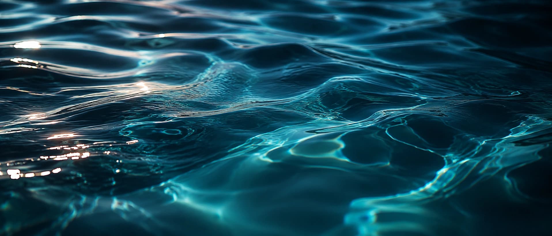 Blue water, soft fabric, skin and light creating a sensual atmosphere